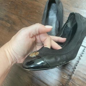 Black Tory Burch ballet flats. Slight tear on one shoe and scuffing on bottom